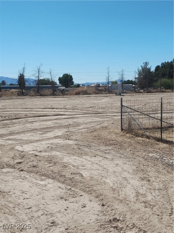 View of yard featuring a rural view and fence