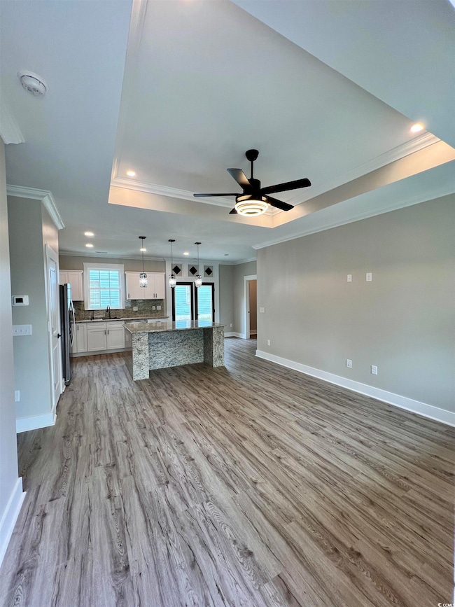 Unfurnished living room featuring crown molding, b