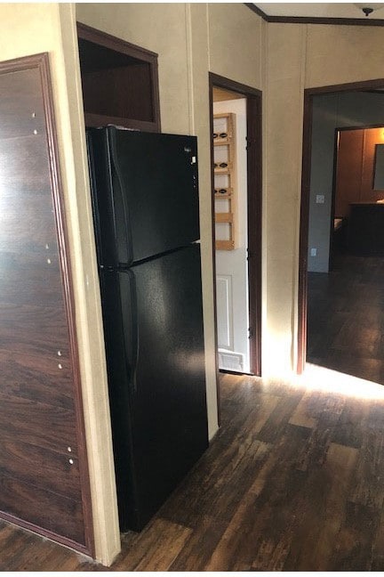 Kitchen featuring dark wood-type flooring and freestanding refrigerator