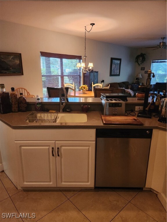 Kitchen with dishwasher, light tile patterned floo
