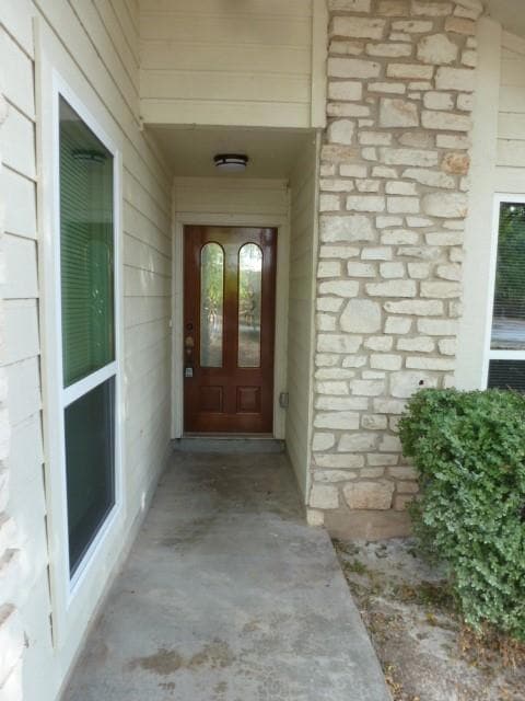 Doorway to property with stone siding