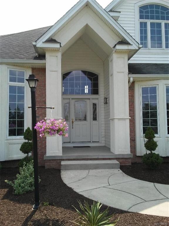 Beautiful covered entryway with large arched trans