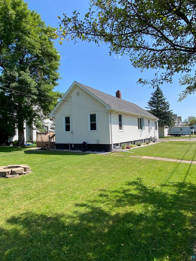 Back of house featuring a yard