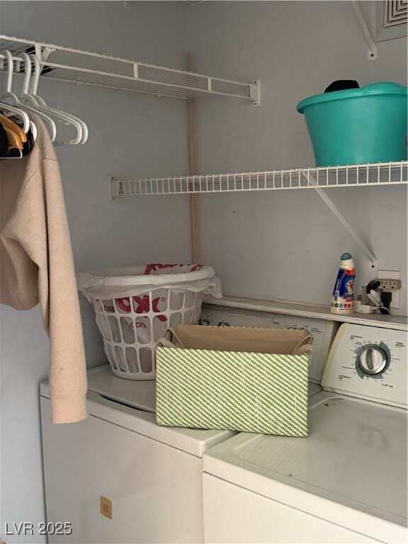 Laundry room featuring washing machine and clothes