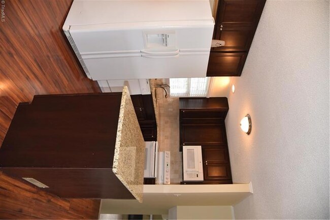 Kitchen with island and granite counter tops.