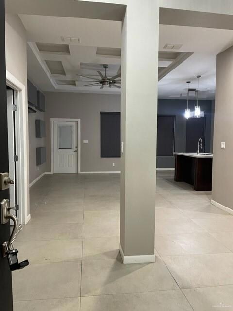 Hall featuring light tile patterned floors