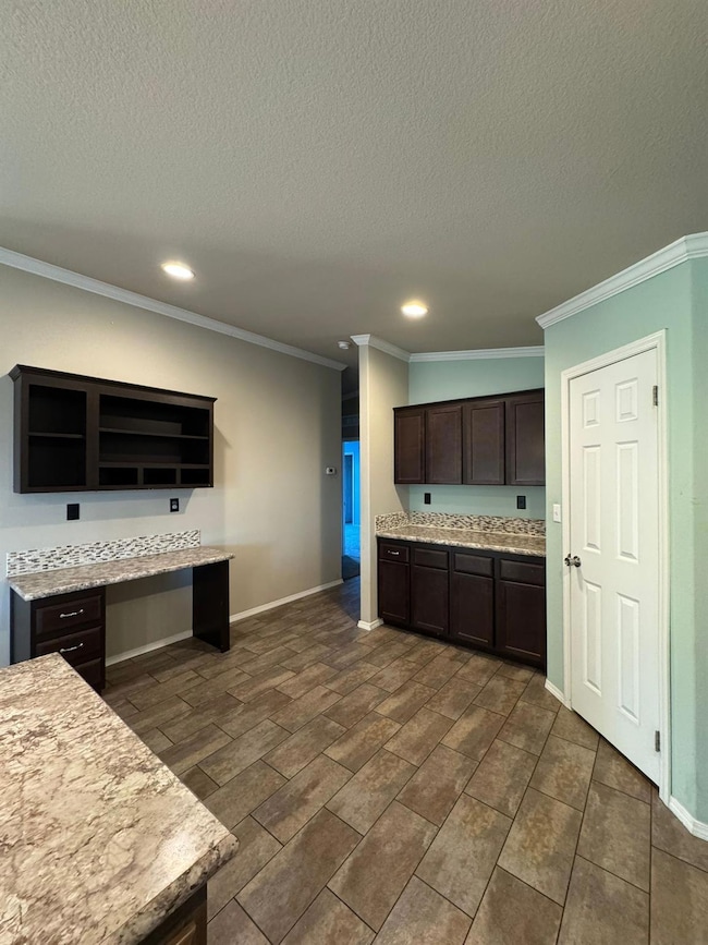 Kitchen with ornamental molding, dark brown cabin