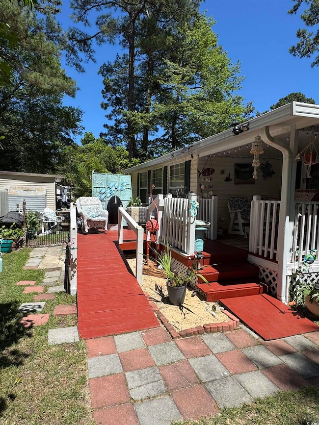 Covered porch featuring area for grilling
