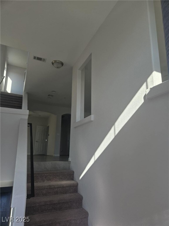 Stairway featuring visible vents