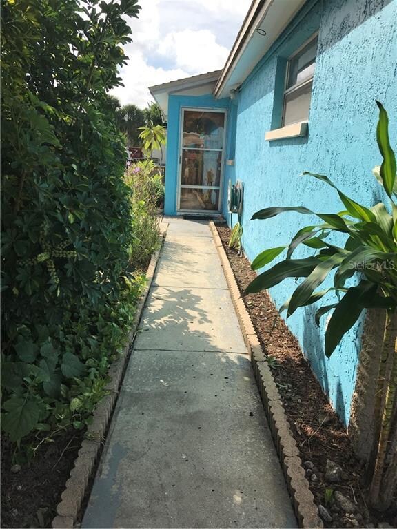 Pathway to front door with plenty of tropical plan