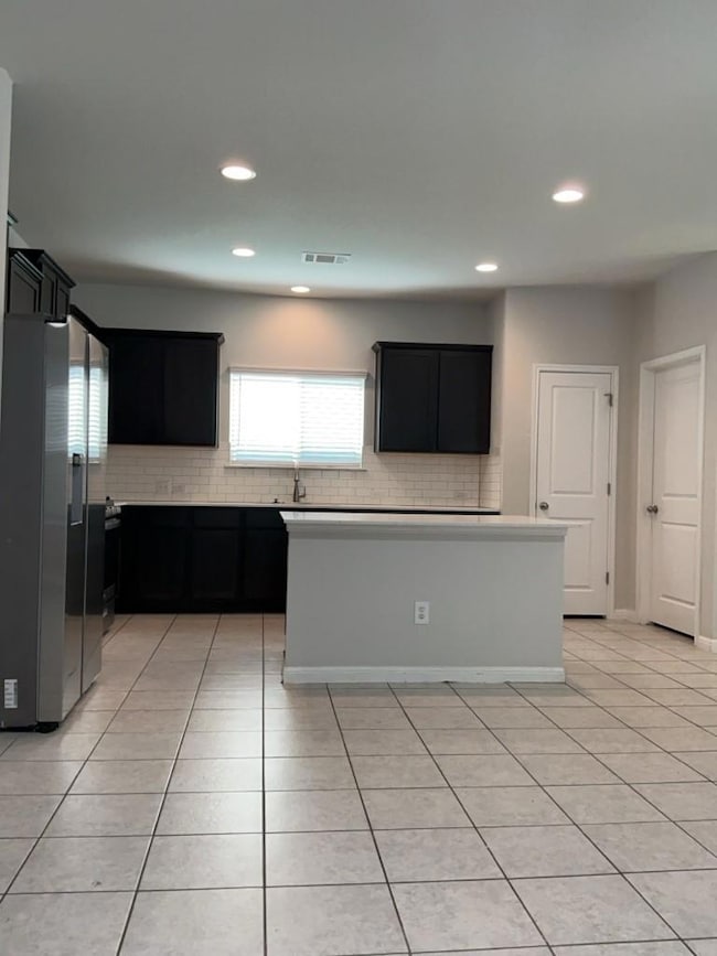 Kitchen with stainless steel fridge with ice disp