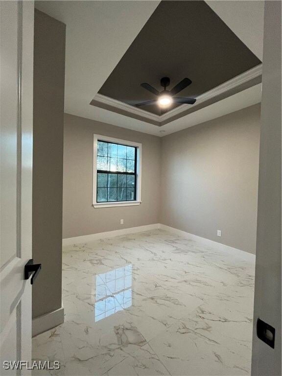 Unfurnished room featuring a raised ceiling, ceili