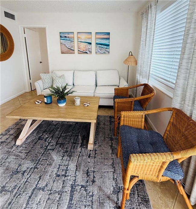 Living room featuring tile patterned floors, visib