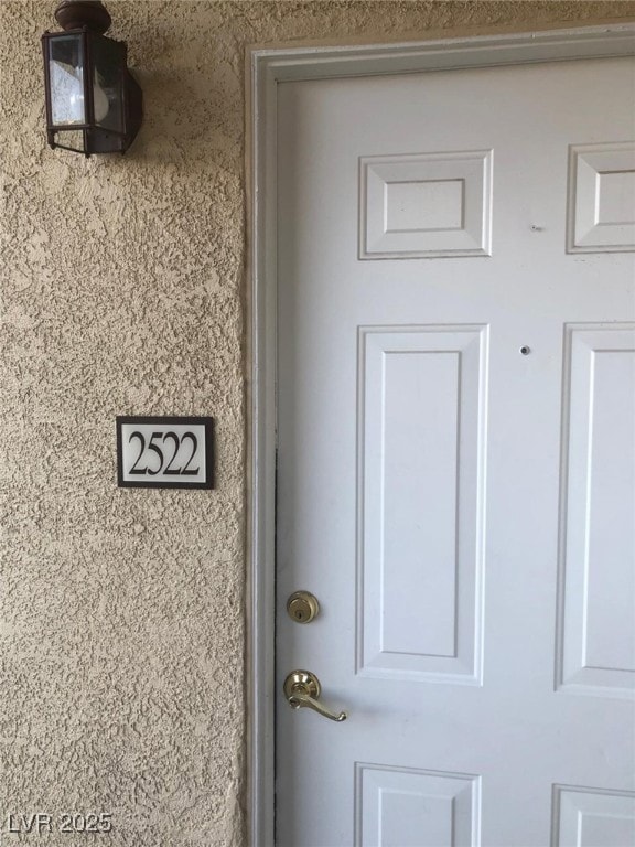 View of exterior entry with stucco siding