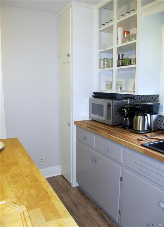 The kitchen has a nice double door pantry cupboard