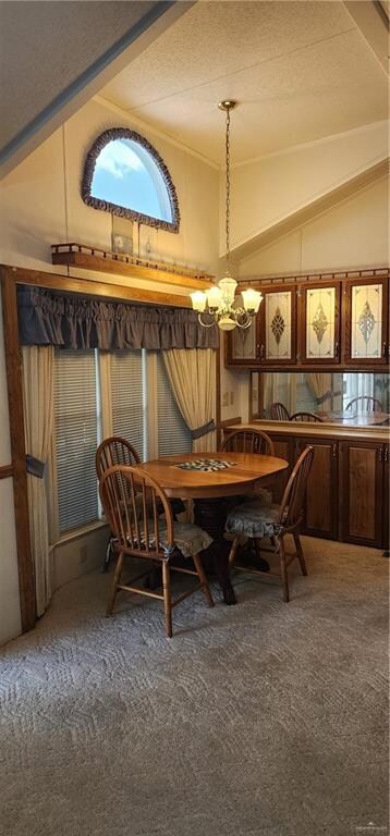 Carpeted dining space with lofted ceiling, a chandelier, and a textured ceiling