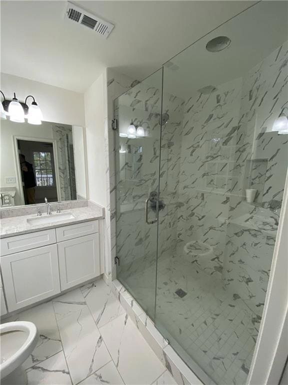 Full bathroom with a marble finish shower, vanity, and marble look tile flooring