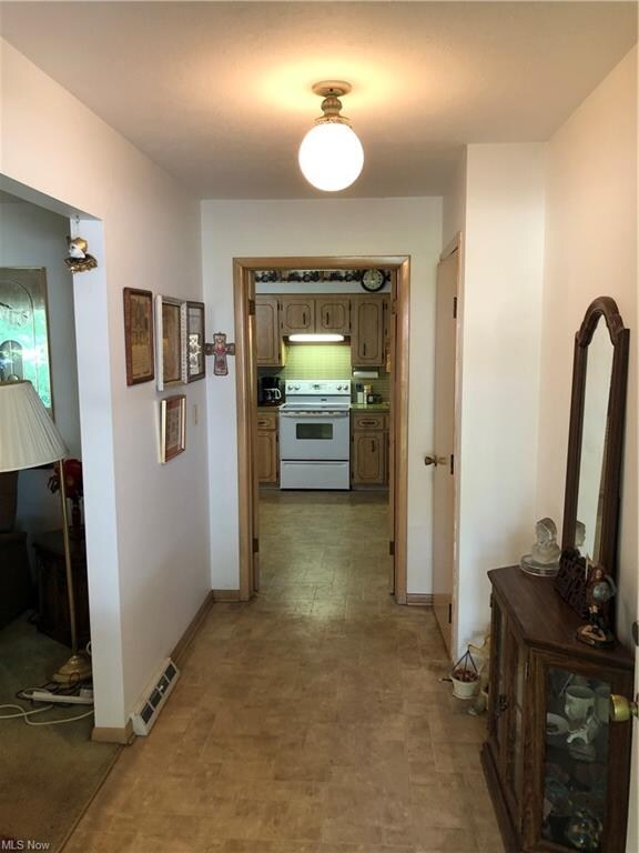 The specious, lighted front foyer has a guest clos