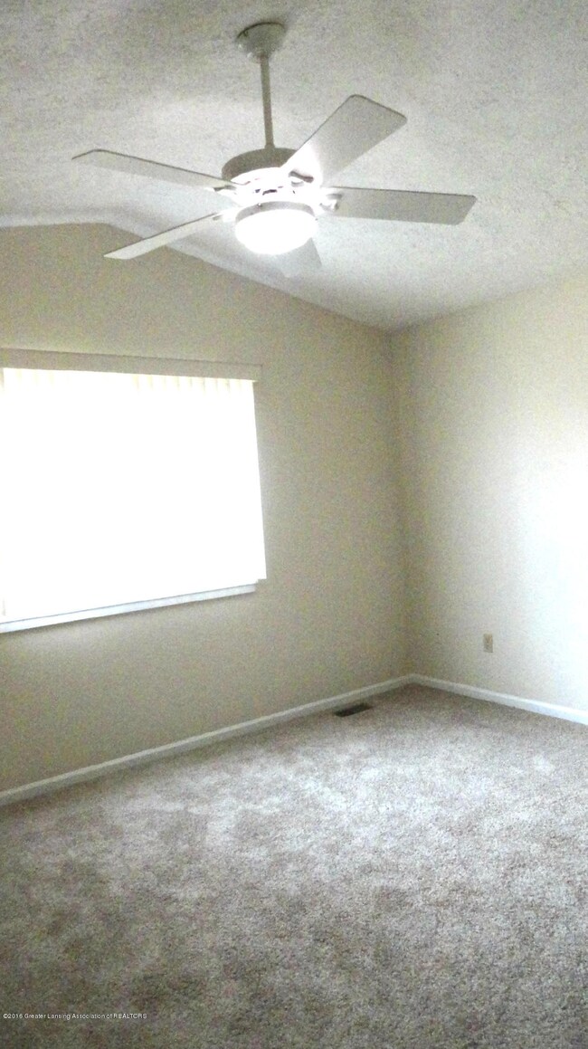 Master bedroom with vaulted ceiling, ceiling fan, freshly painted and new carpet.
