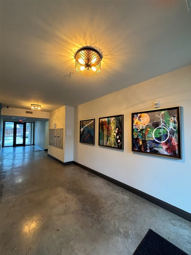 Unfurnished living room featuring concrete flooring and baseboards