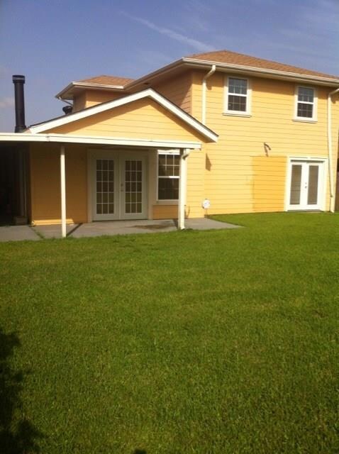 Rear view of house. Covered patio.