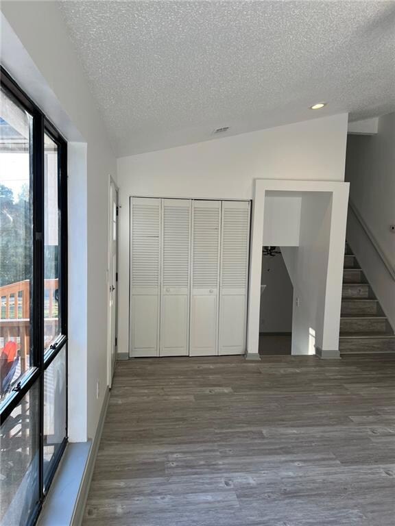 Unfurnished bedroom featuring dark hardwood / wood