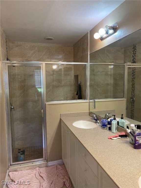 Full bathroom with a shower stall and vanity