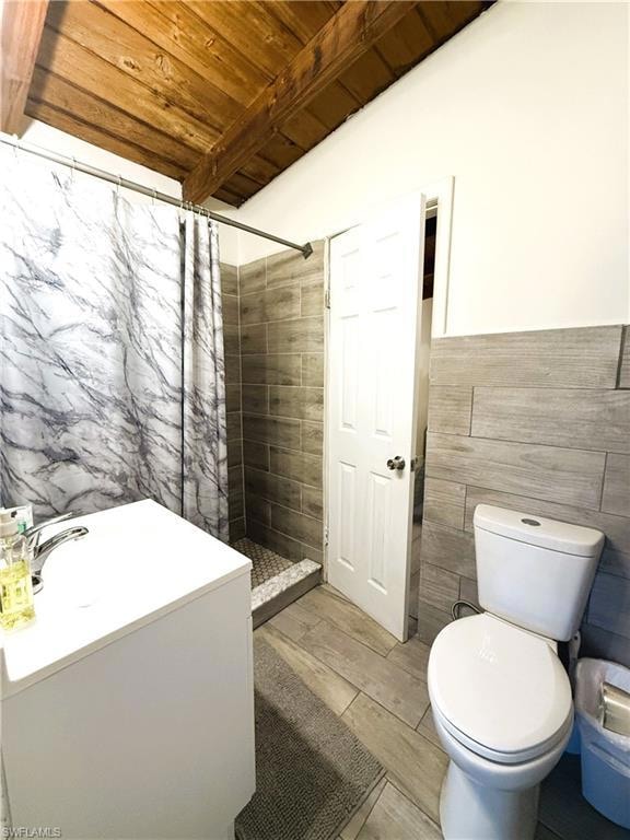 Bathroom featuring tile walls, wood ceiling, a sho