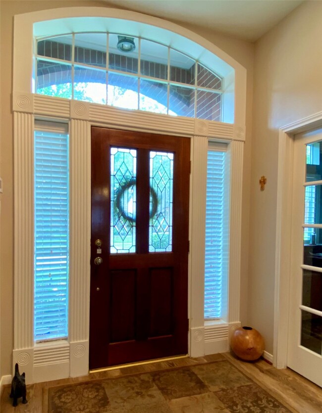 Well-lit foyer with a transom window and sidelight windows.