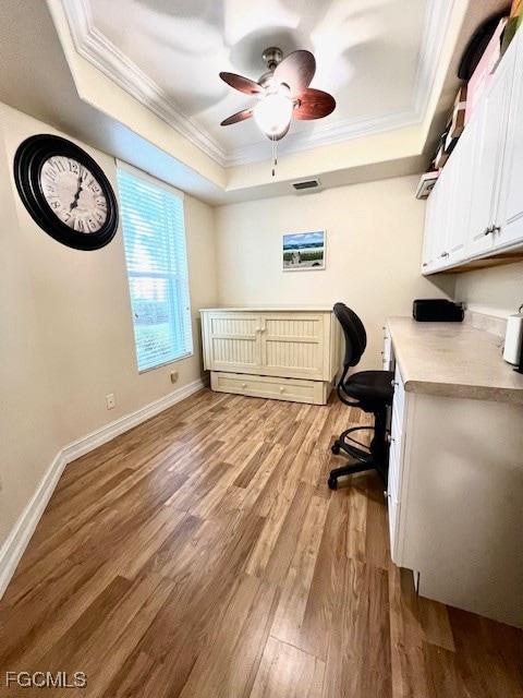 Den/Office with a coffered ceiling and vinyl flooring.  There is a desk and a murphy bed.