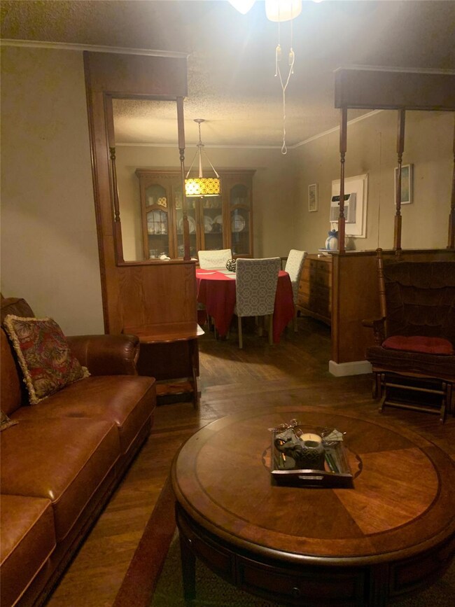 Living room featuring a wall mounted AC, hardwood 