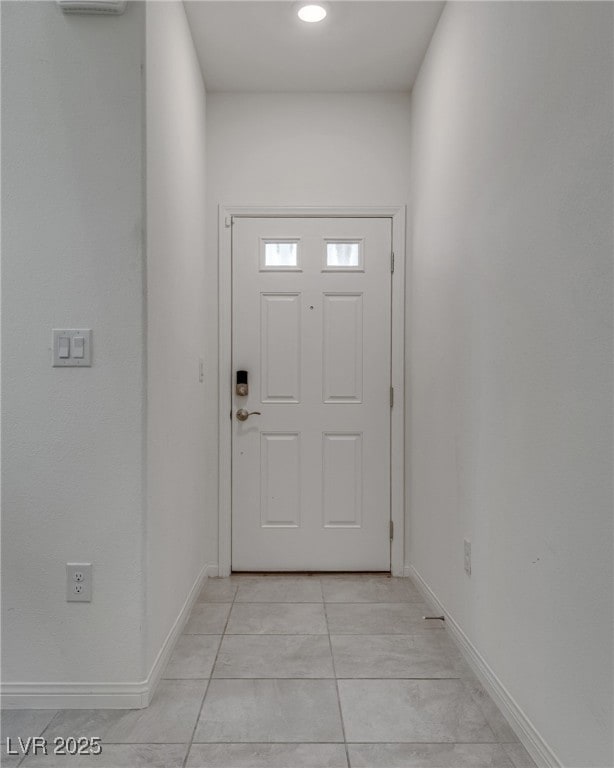 Entryway with baseboards and light tile patterned
