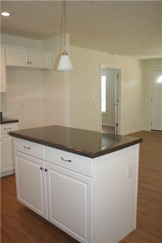 Island has storage with decorated lighting.