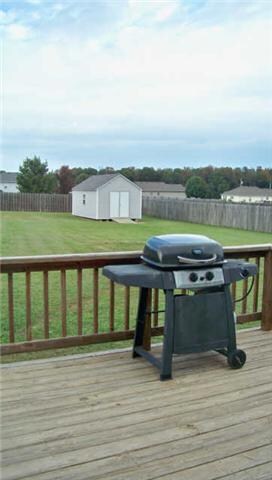 View of the back yard and privacy fence from the deck