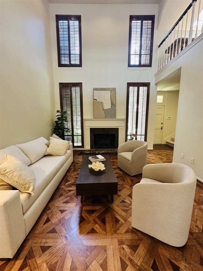 Dramatic living room with 20-foot ceilings, wood-b