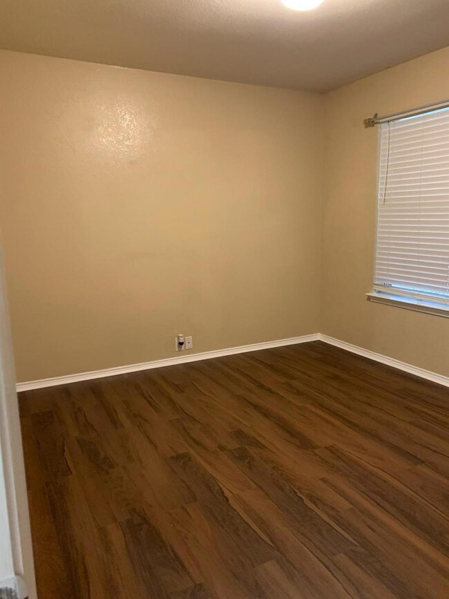 Spare room with dark wood-type flooring
