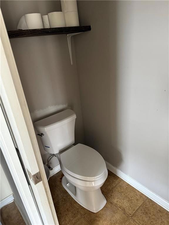 Bathroom featuring toilet and tile patterned flooring