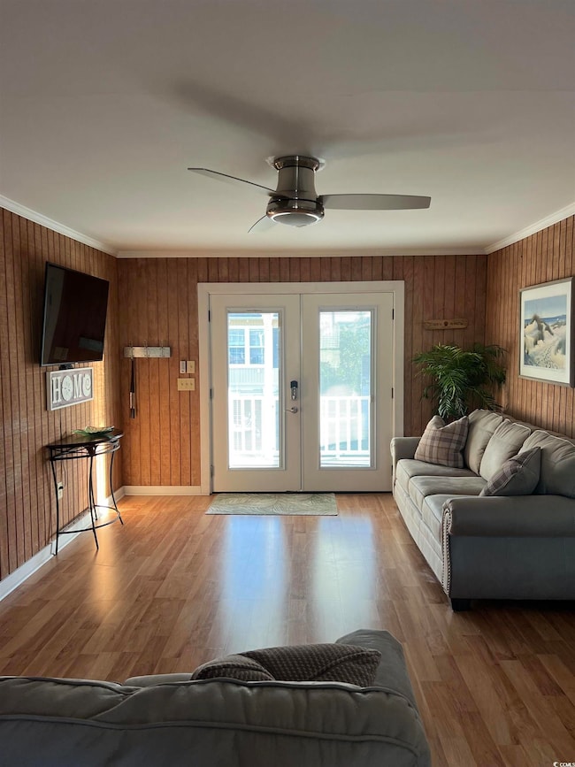 Living room with ceiling fan, ornamental molding, 