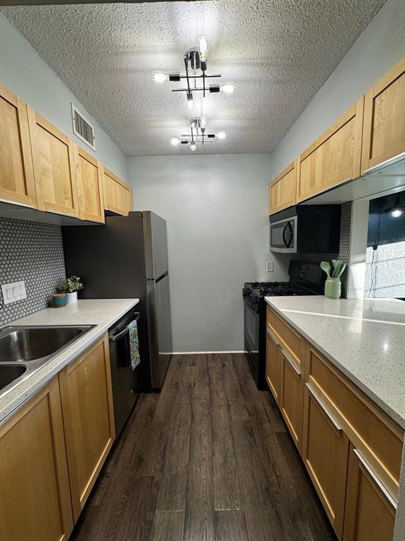 Kitchen featuring black gas stove, dishwasher, da