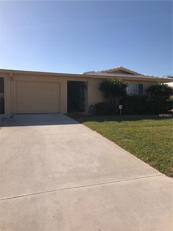 FRONT VIEW WITH LARGE DRIVEWAY