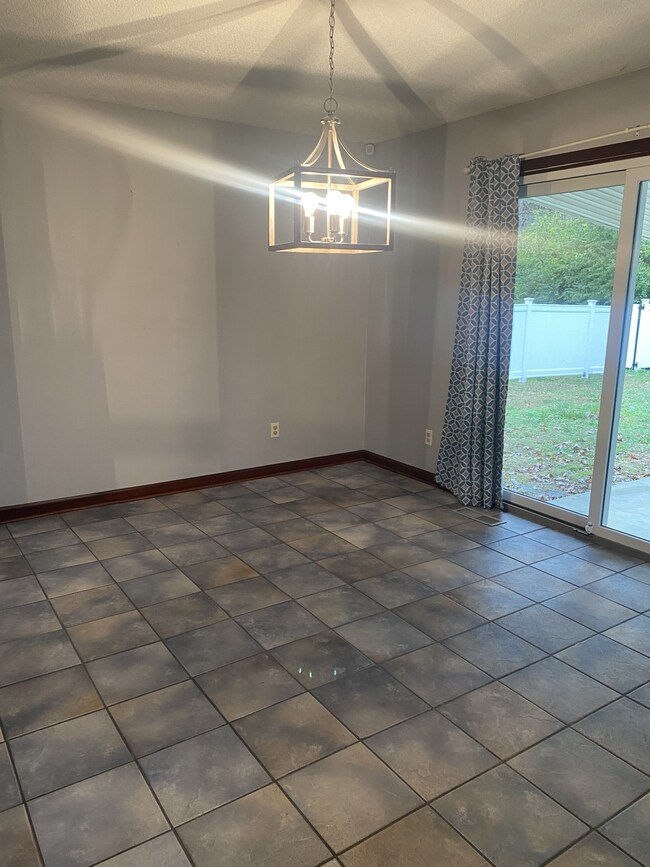 This extra large breakfast room is bright and sunny and looks out onto the covered patio