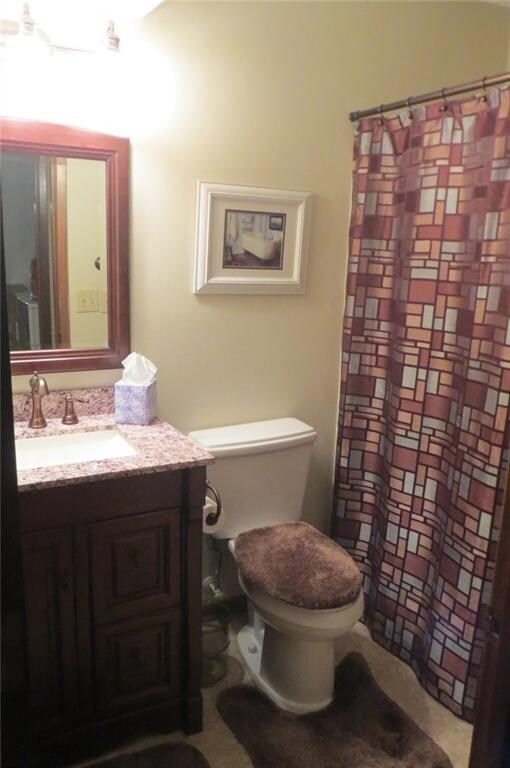 Remodeled bathroom with granite counter tops and u