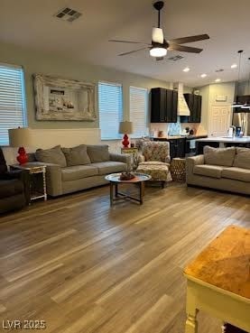 Living room featuring light wood-style floors and ceiling fan