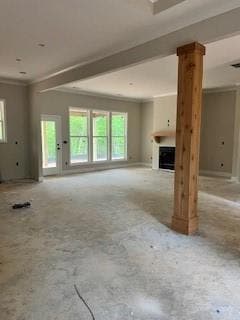 Unfurnished living room with ornamental molding an