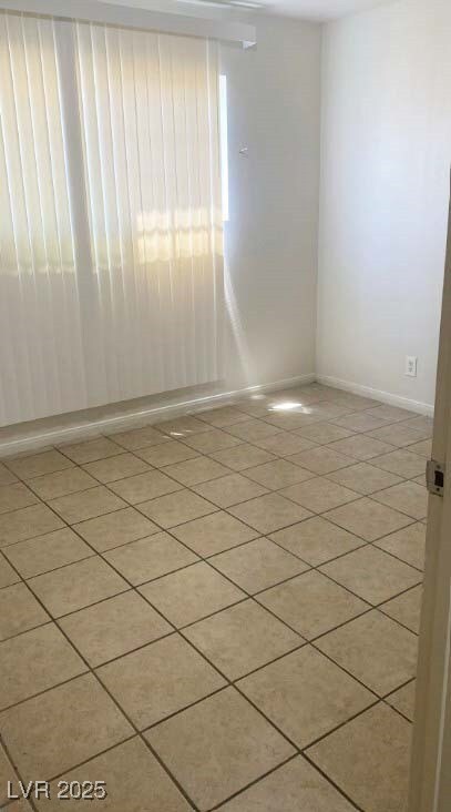 Empty room featuring light tile patterned floors a