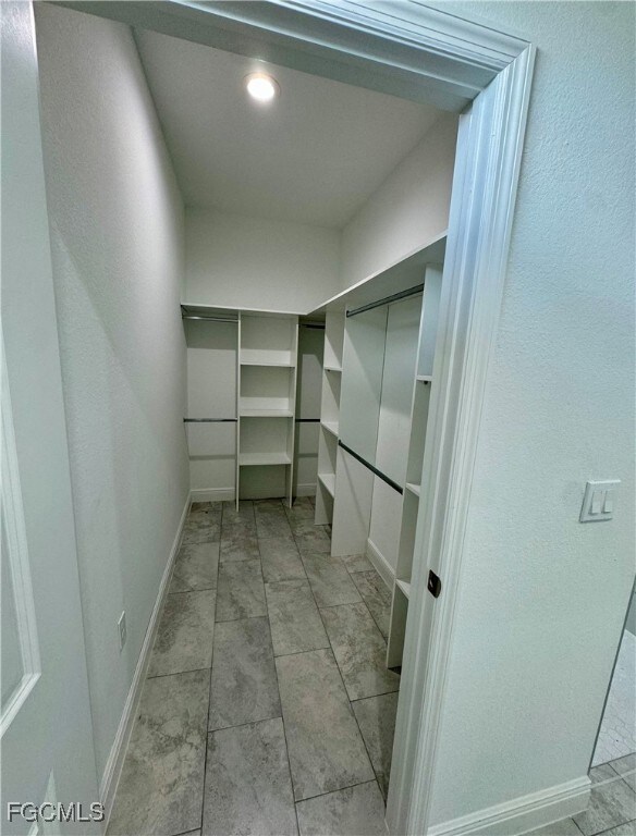 Spacious closet featuring light tile patterned floors