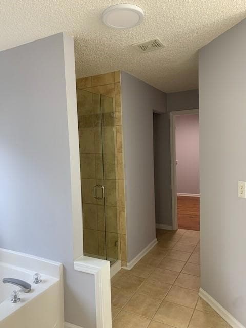 Full master bath featuring a garden tub, tile patt