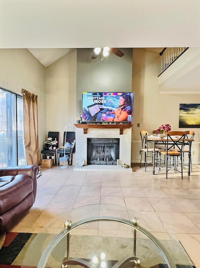 Living area with tile patterned floors, a brick fi