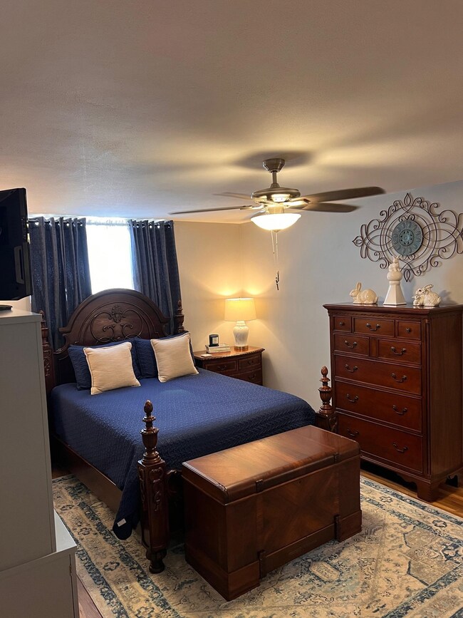 Bedroom with light hardwood / wood-style flooring 