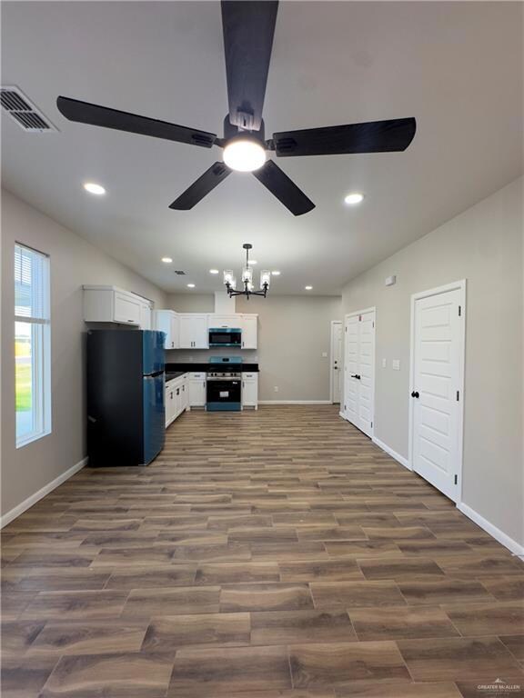 Kitchen featuring stainless steel appliances, ceiling fan, dark wood finished floors, baseboards, and recessed lighting